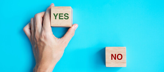 Hand choosing Yes or No block. Answer, question and decision concept