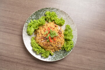 golden stir fried egg omelette with seafood and meat on wood table asian Thai appetiser halal menu