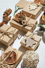 Gift box.Christmas zero waste box eco friendly packaging.Flat lay packs gifts kraft paper green ribbon white background,ecological Christmas holiday concept,eco decor,gift background,holiday