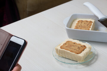 A woman photographs homemade ice cream. Cookies and cream. Close-up shot.