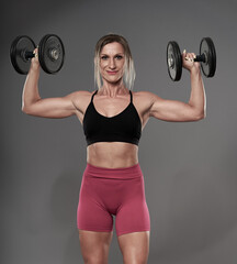 Fototapeta na wymiar Female bodybuilder working out