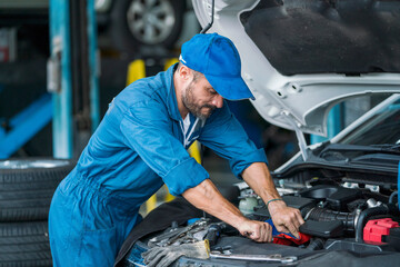 Auto mechanic hands using wrench to repair a car engine. Auto mechanic man automotive diagnostic Checking car service, repair, maintenance.