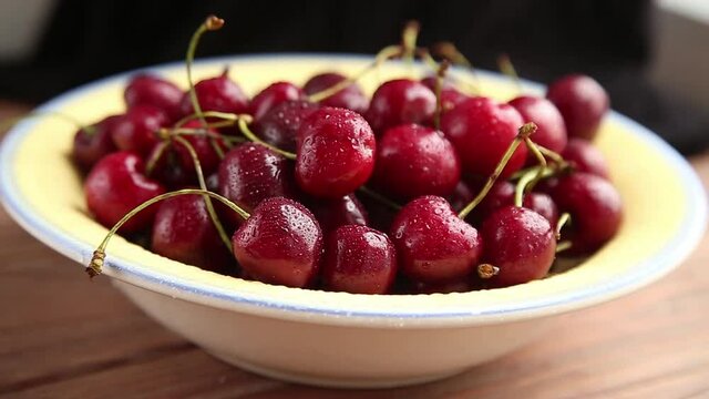 Drops of water fall on cherries