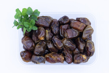 pile of dates with green leaf garnish