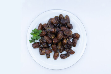pile of dates with green leaf garnish