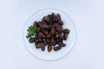 pile of dates with green leaf garnish