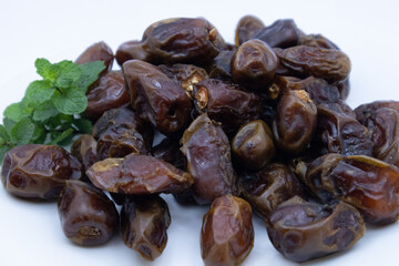 pile of dates with green leaf garnish