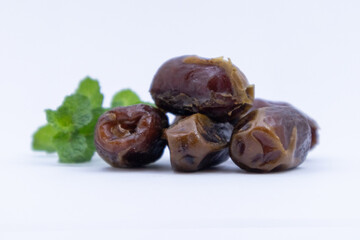 pile of dates with green leaf garnish
