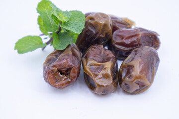 pile of dates with green leaf garnish