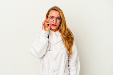 Caucasian doctor woman isolated on white background with fingers on lips keeping a secret.