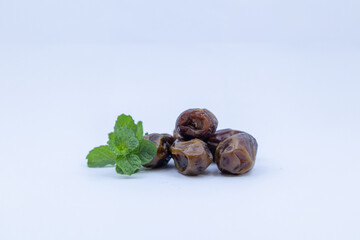 pile of dates with green leaf garnish