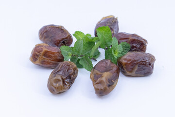pile of dates with green leaf garnish
