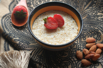 oats flakes and strawberry on wooden table 