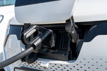 Electric car on charging spot. Car sharing commuter charging station. E-mobility, electric car...