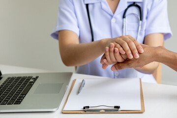 Close up of patient and doctor ,Hand of doctor reassuring patient,Medical ethics and trust concept,...