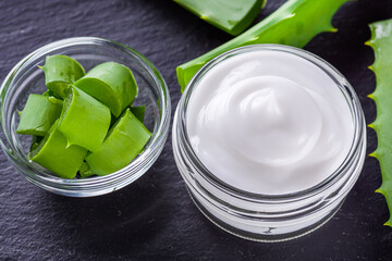 natural aloe vera cream on a dark stone background