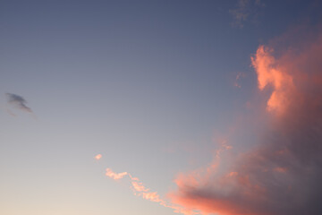 Background. Dramatic sunset. Red-orange clouds against the blue sky. Sunset orange red yellow pink...