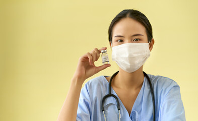 Asian Doctor show vaccine bottle for injection to patient to protect people form covid19