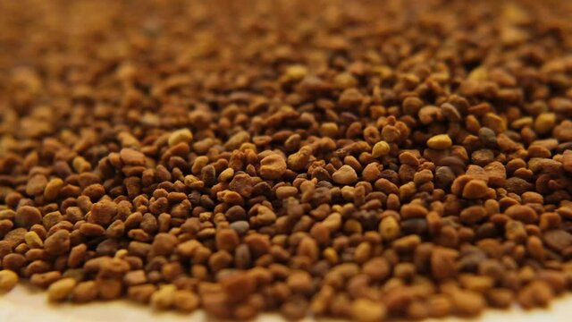 propolis. Beekeeping product. honey propolis granules close-up. Honey and pollen.Falling propolis granules. Slow motion