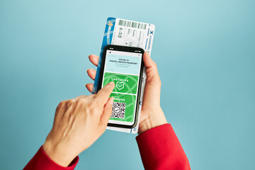 Digital covid certificate. Covid negative rapid digital test pass. Woman passenger holding digital medical pass on her mobile phone and airplane ticket. Traveler showing digital covid test