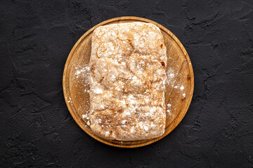 Whole grain bread on cuttin board. Top view