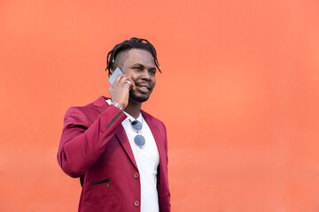 stylish black man in suit talking on phone