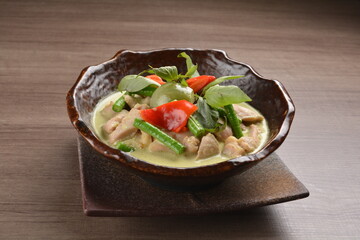thai green curry hot spicy soup with beef or chicken with vegetables on wood background asian halal menu