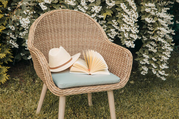 Book on an armchair in the garden. Reading outside in summer 