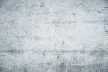 White painted old brick wall with red cracked bricks.