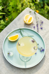 Top view Pompadour glass of lavender lemonade with cube ice with lavender flowers