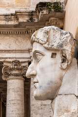 Close-up on male profile of ancient roman statue in ruins