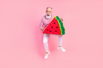 Photo of pretty funky gentleman wear sweater spectacles jumping holding watermelon slice isolated pink color background