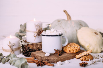 Autumn composition with cocoa with marshmallows, cookies, pumpkin and candles. 