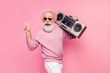 Profile photo of nice funny grey hair aged man with boom box wear eyewear cap sweater isolated on pink background