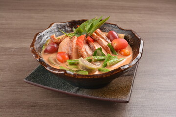 thai red curry hot spicy soup with duck or chicken with vegetables on wood background asian halal menu