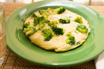 Fototapeta na wymiar wholesome breakfast. omelet with broccoli on green plate