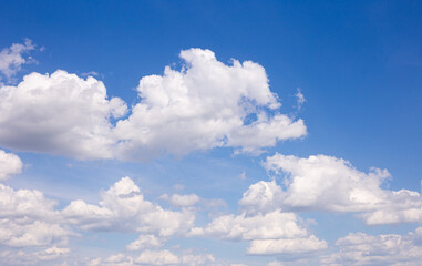 Naklejka na ściany i meble cumulus clouds against blue sky