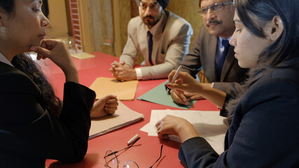 Group of Indian co-workers brainstorming during a business meeting