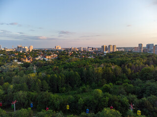 Obraz premium Cable car attraction aerial view in green summer Kharkiv city popular recreation Central Park, Sarzhyn Yar. Recreation area in city center