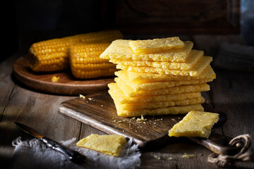 Cornbread stacked on a rustic table
