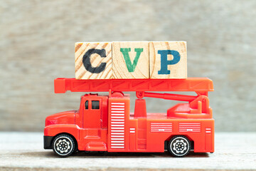 Fire ladder truck hold letter block in word CVP (Abbreviation of (Cost Volume Profit or Central venous pressure) on wood background
