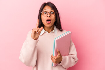 Young student latin woman isolated on pink background having an idea, inspiration concept.