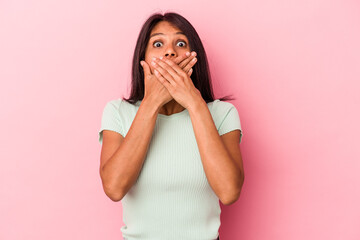Young latin woman isolated on pink background shocked covering mouth with hands.