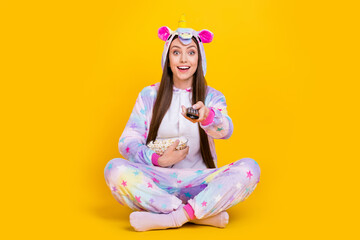 Obraz na płótnie Canvas Portrait of attractive cheerful trendy girl wearing funny costume watching tv show isolated over bright yellow color background