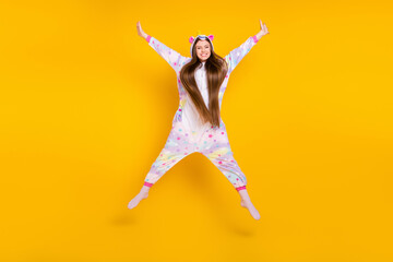 Fototapeta na wymiar Full length body size view of attractive cheerful girl having fun jumping isolated over bright yellow color background
