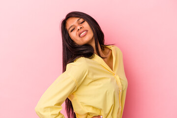 Fototapeta premium Young latin woman isolated on pink background suffering a back pain.