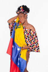 Playful latina woman holding the Venezuelan flag