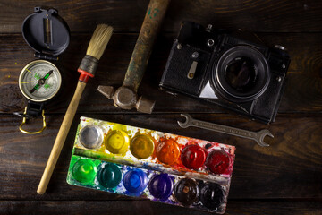 compass camera paint brush key on the table
