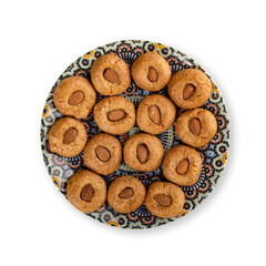 Traditional Moroccan handmade cookies on a plate, isolated on white.