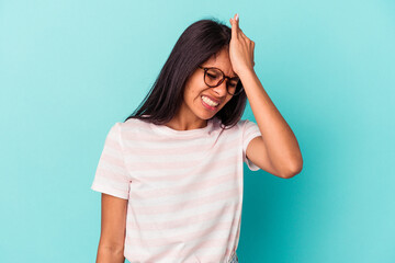 Young latin woman isolated on blue background forgetting something, slapping forehead with palm and closing eyes.